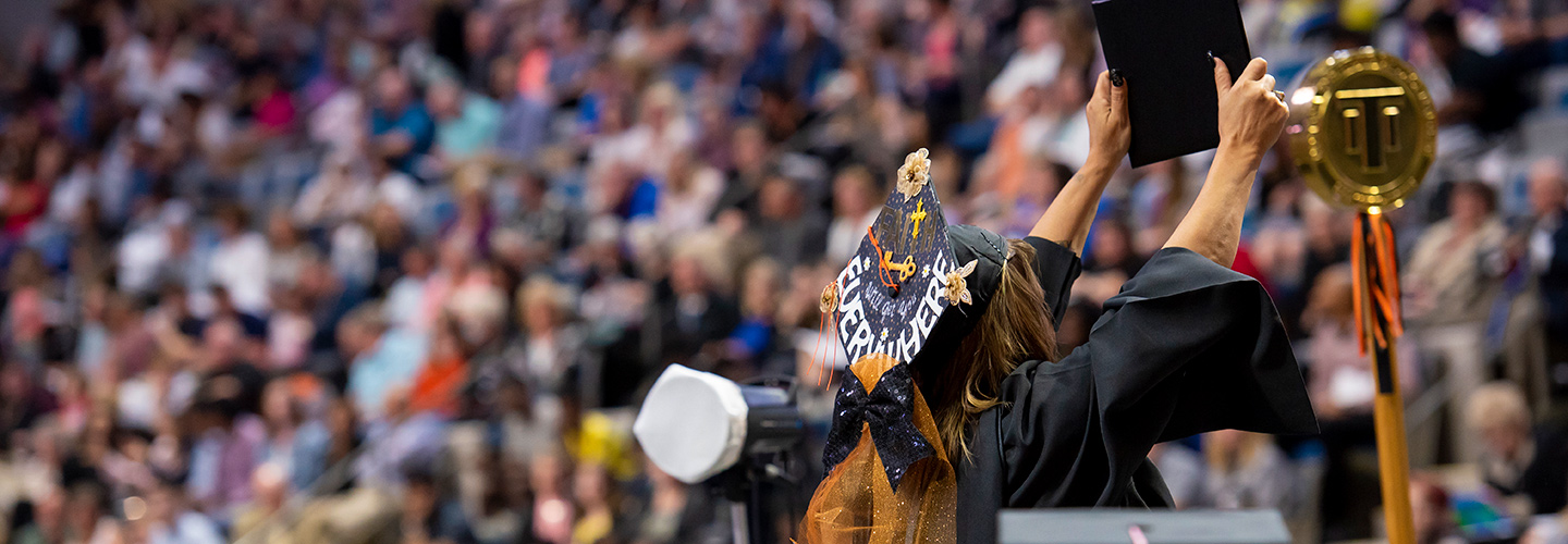 A graduating student celebrating during the 2018 commencement