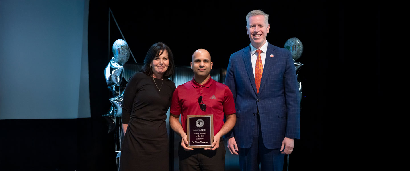 Dr. Naga Musunuri accepting faculty of the year award